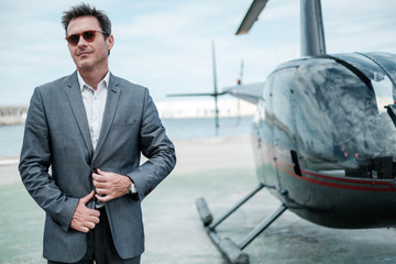 Businessman near private helicopter