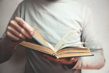 Caucasian man reading bible.