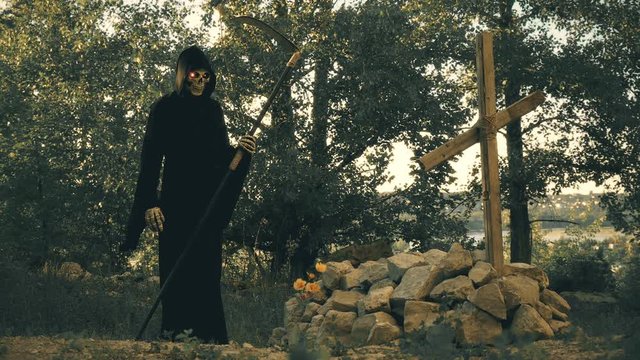 silhouette of death with oblique and glowing eyes throwing flowers at the grave of the one whom she took with her