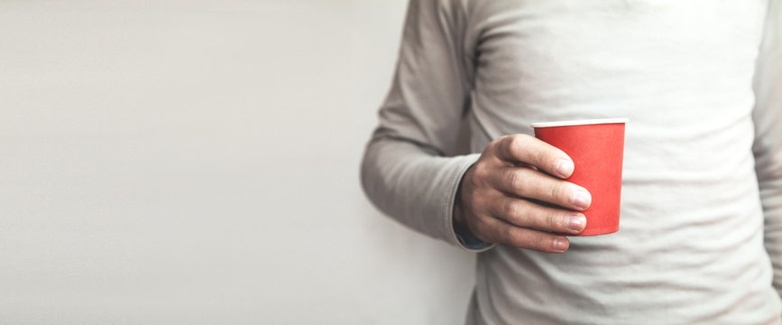 Man Holding Red Paper Cardboard Coffee Cup.