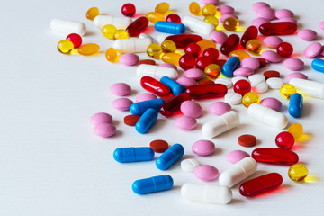 Different colorful medicines. Pills and capsules on white background. Copy space.