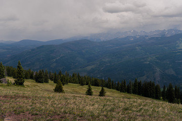 A stormy, landscape view of a mountain range seen from Vail, Colorado. 