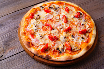 Pizza with cherry tomatoes, ham and mushrooms, traditional Italian recipe, delicious mediterranean meals. Food delivery, restaurant, pizzeria menu concept