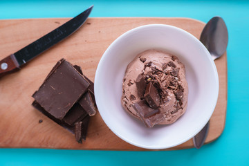 Chocolate sundae ice cream in white bowl, flat lay. Summer seasonal sweets, cold refreshing dessert