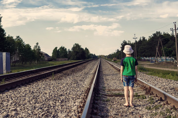 The child goes on rails, walks on rails. Danger, road, choice of profession.