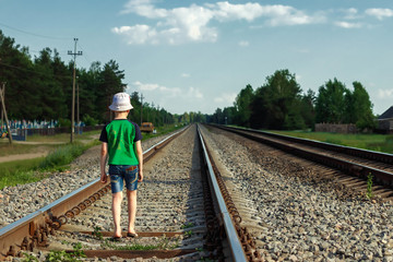 The child goes on rails, walks on rails. Danger, road, choice of profession.