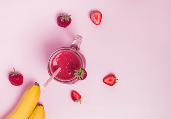 Delicious strawberry and banana smoothie on the pink background