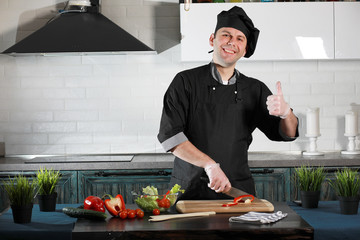 Man cook preparing food at the kitchen of vegetables