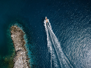 Motor boat cruising along the Atlantic ocean coast during a sunny day