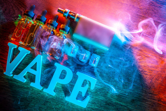 the inscription VAPE Electronic Cigarette. Liquid for VAPE. Steam from an electronic cigarette. VAPE concept