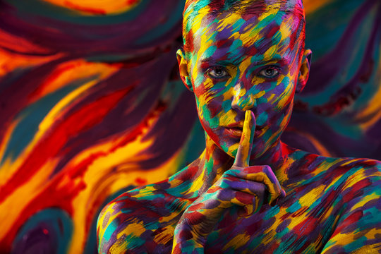 Portrait of the bright beautiful woman with art colorful make-up and bodyart
