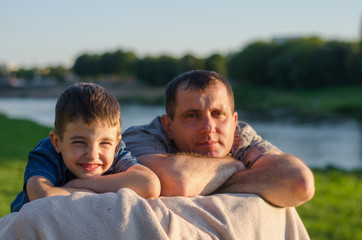 
little boy playing with dad in the park
