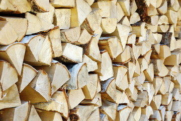 birch wood in the woodpile for oven or fireplace texture background