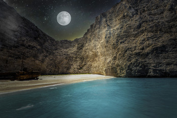 Amazing night landscape of Navagio beach with shipwreck on Zakynthos island, starry sky and a full...