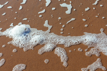sand beach foam surf water shore blue yellow spring summer white top view close-up abstract different sun morning soft