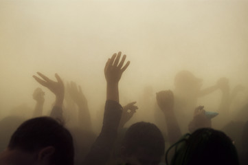 Hands in mist and dust like a disaster.