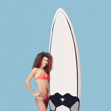 Portrait exotic girl posing with surfboard 