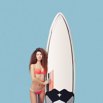 Portrait exotic girl posing with surfboard 