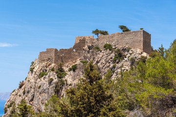 Fototapeta na wymiar The castle of Monolithos located at the summit of the tall and craggy rock. Rhodes island, Greece