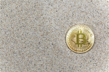 coin bitcoin buried in the sand. Bitcoin is the most popular cryptocurrency in the world.