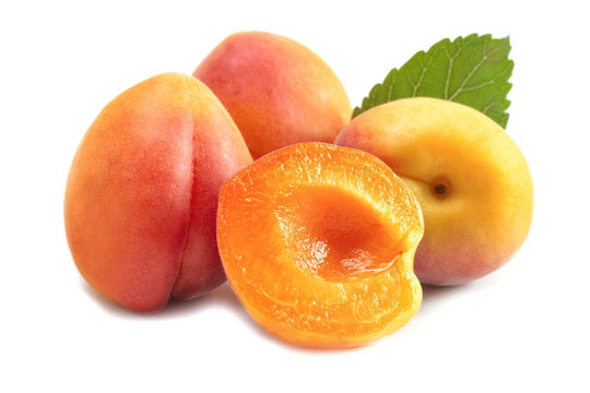 a bunch of ripe juicy colorful apricot with a cut half
