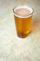Close up on a pint of beer on a topographical map