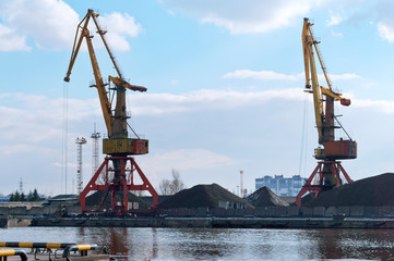 Seaport on the Baltic sea. Сommercial port. Port cranes and machinery.