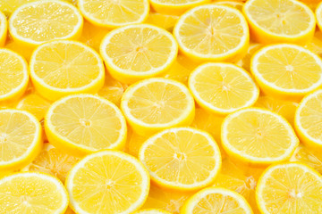 A slices of fresh juicy yellow lemons.  Texture background, pattern