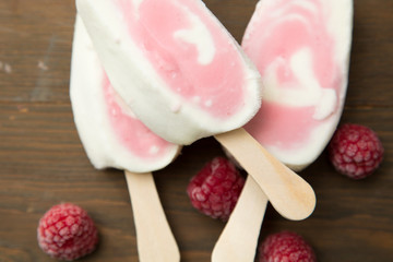 Popsicle with fresh raspberry on a table