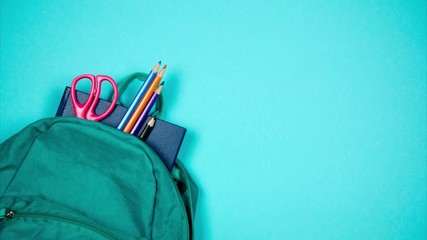 From the school bag appear books, pencils and pens. Place for inscription. Stop motion - Powered by Adobe