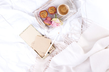 white bed, fresh coffee, breakfast cakes and a bouquet of pink roses. Good morning Vintage photo. Copy space.