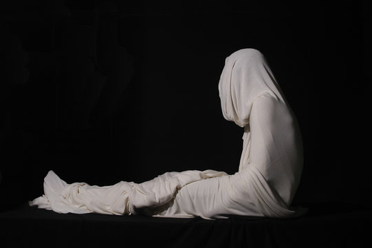 Jesus Christ rising from the dead wrapped in white cloth. Easter Sunday, resurrection of Jesus after three days dead in Jerusalem. Resurrection and Christian concept. Life after death.