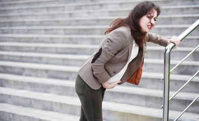 A pregnant woman feels pain on the street