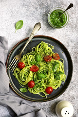 Spaghetti pasta with pesto sauce and cherry tomatoes.Top view.
