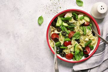 Pasta salad with vegetable (green bean, cucumber, tomatoes and olive).Top view.