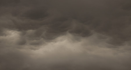 Light in the Dark and Dramatic Storm Clouds background