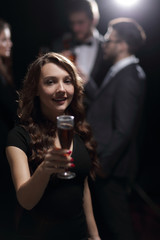 happy young woman raising glass in toast