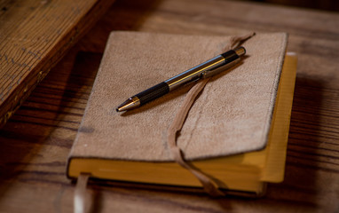 Modern Pen resting on an old journal