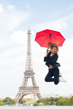 Happy woman travel in paris, france. Woman jump with fashion umbrella. Girl with beauty look at eiffel tower. Parisian isolated on white background. Travelling and wanderlust. Enjoy summer vacation