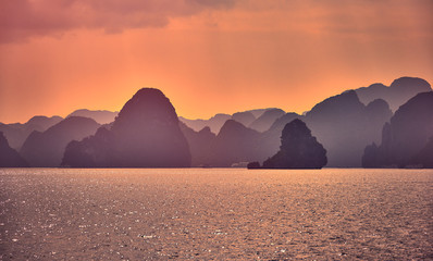 Fototapeta na wymiar Halong bay boats,Sunset at Ha Long Bay scenic view , Hanoi, Vietnam , Southeast Asia