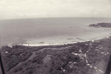 black and white view of the beach edge from the sky