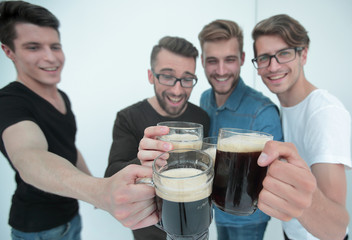 close up.mugs of beer in the hands of a group of men
