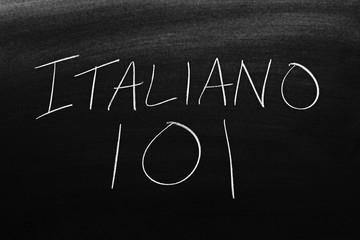 The words Italiano 101 on a blackboard in chalk.  Translation: Italian 101