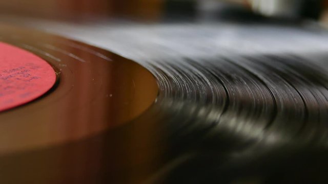 The vinyl record is spinning on the turntable. Retro music. Clean sound of the plate. Soundtrack. Sound recording studio.