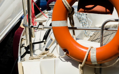 Orange lifebuoy on the side of the boat, an essential tool life-saving at sea
