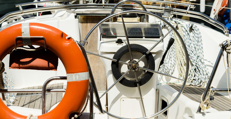 Obraz premium Orange lifebuoy on the side of the boat, an essential tool life-saving at sea