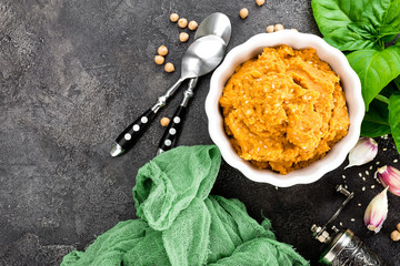 Hummus. Fresh homemade hummus with paprika, sesame, salt, garlic, tahini, lemon juice and olive oil. Chickpea hummus in bowl