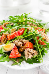 Salad with tuna. Vegetable salad with boiled egg, tuna and arugula. Fish salad