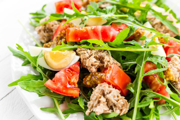 Salad with tuna. Vegetable salad with boiled egg, tuna and arugula. Fish salad