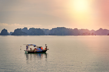 Ha Long Bay , Vietnam-29 November 2014:Fishing boat in Ha long Bay, Panoramic view of sunset in Halong Bay, Vietnam, Southeast Asia,UNESCO World Heritage Site